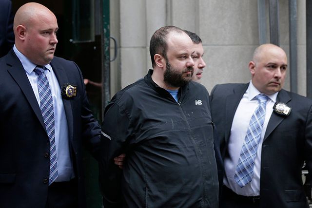 Marc Lamparello being escorted from the Midtown North police precinct